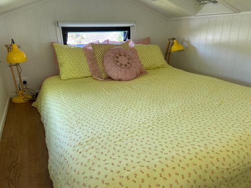 a bedroom with a large bed in a small room at Tiny House in Woonona