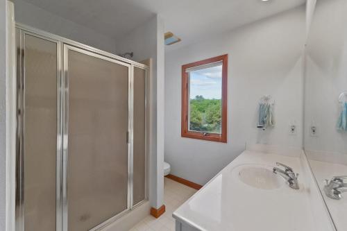 a white bathroom with a shower and a sink at Ss OBX SS111 in Southern Shores