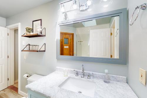 a bathroom with a sink and a mirror at Deere Run 3B in White River Junction