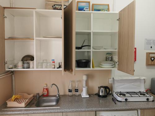 a kitchen with a sink and a counter top at Nicosia rooms Studios in Nicosia