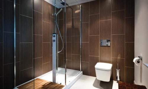 a bathroom with a glass shower with a toilet at Harrison Stickle in Bowness-on-Windermere
