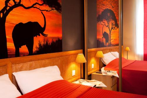 a hotel room with two beds and a painting of an elephant at Anturage Hotel in Saint Petersburg