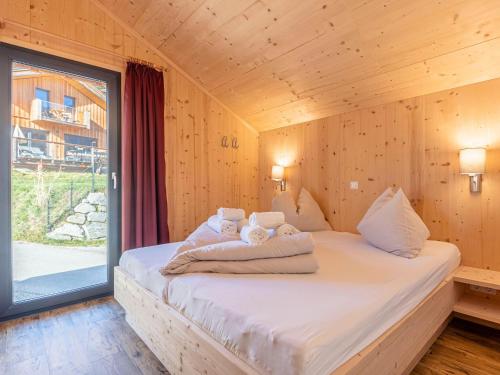 a bedroom with a bed with towels on it at Gorgeous Chalet in Steinach am Brenner near Ski Area in Steinach am Brenner