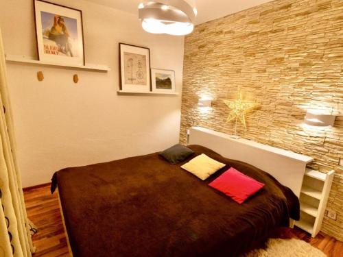 a bedroom with a large bed with a brick wall at Apartment in thermal and winter sports resort of Bad Gastein in Bad Gastein