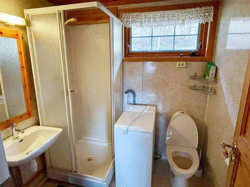 a small bathroom with a toilet and a sink at 6 person holiday home in Åkra-By Traum in Kyrping