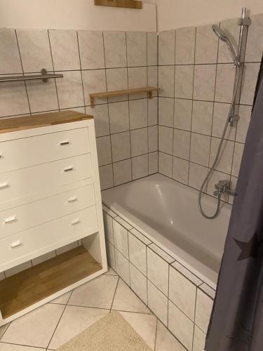 a bathroom with a white tub and a white cabinet at B&B bei Pepe Nero. in Sankt Pölten