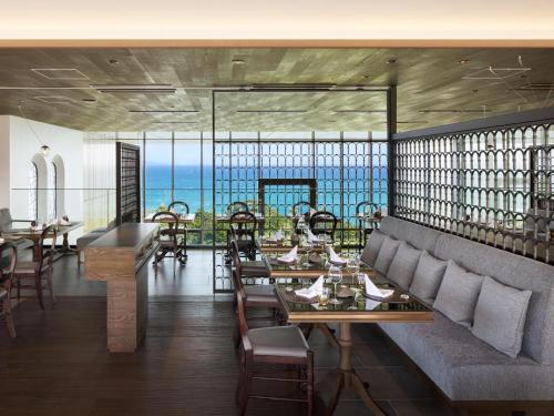 a restaurant with tables and chairs and a view of the ocean at GOTO RETREAT by Onko Chishin in Goto