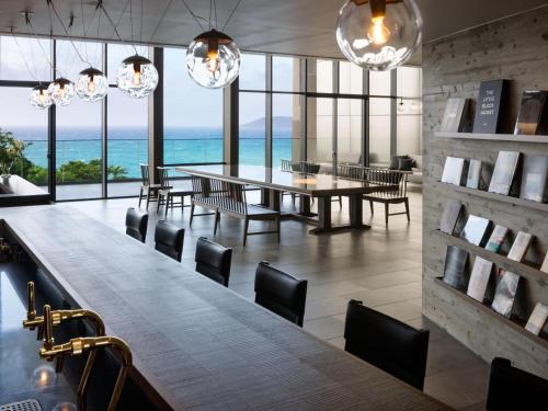 a dining room with a table and chairs and the ocean at GOTO RETREAT by Onko Chishin in Goto