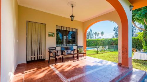 a view from the living room of a house with an archway at Huerta Tío Pipa Aznalcázar by Ruralidays in Aznalcázar