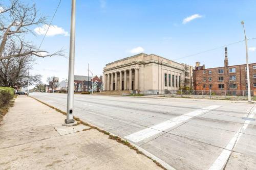 an empty street in front of a large building at Stately Studio Apartment in Detroit