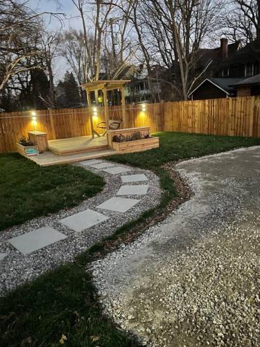 a backyard with a bench and a wooden fence at Stately Studio Apartment in Detroit