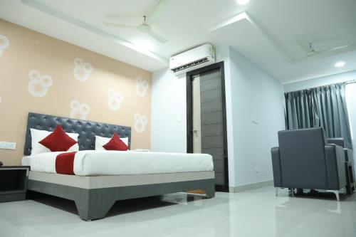 a bedroom with a bed and a tv in it at HOTEL BLUE MOON in Nellore