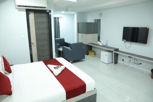 a hotel room with a bed and a tv at HOTEL BLUE MOON in Nellore
