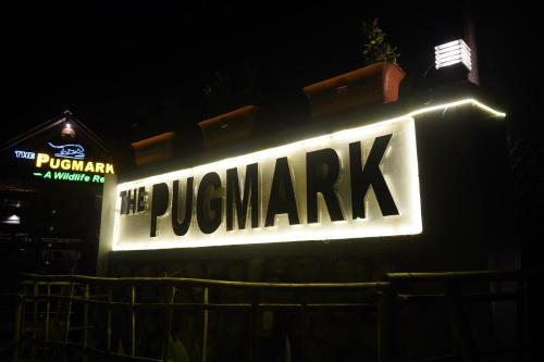 a sign for the pucampak sign in the dark at The PugMark Wildlife Resort in Jyoti Gaon