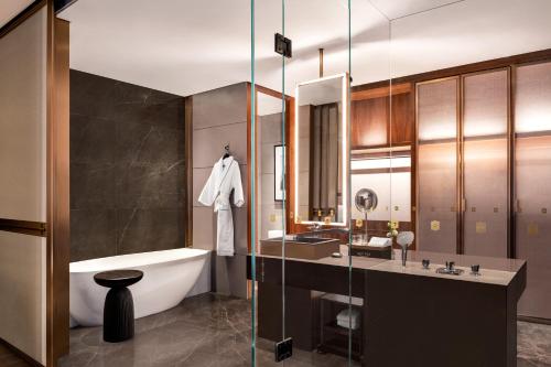 a bathroom with a tub and a sink and a bath tub at Shangri-La Nanning - The tallest hotel worldwide in Shangri-La Group in Nanning