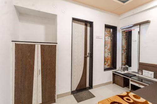La salle de bains est pourvue d'un lavabo, d'une douche et d'un miroir. dans l'établissement Hotel Vyankatesh & Pure Veg Restaurant, à Mahabaleshwar