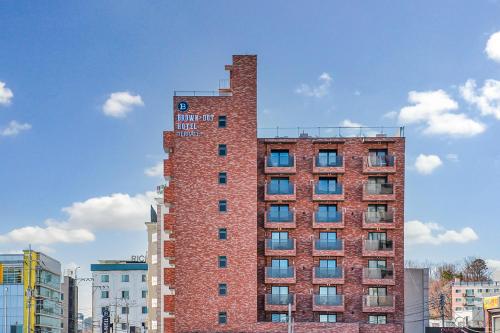 a tall red brick building with a clock on it at Browndot Terrace Pohang Passenger Terminal in Pohang
