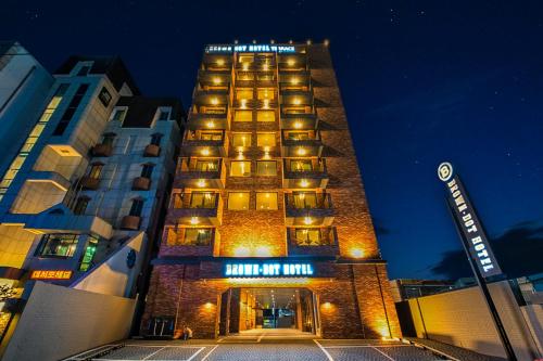 a tall building with a sign on it at night at Browndot Terrace Pohang Passenger Terminal in Pohang