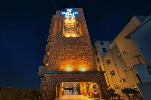 a tall building with a clock tower at night at Browndot Terrace Pohang Passenger Terminal in Pohang