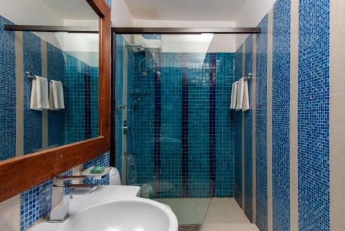 a bathroom with a shower and a toilet and a sink at Casa Baga in Baga