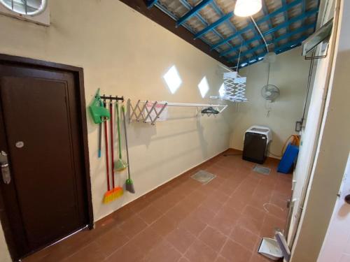 a room with hockey sticks on the wall at Homestay LA Kota Bharu in Kota Bharu