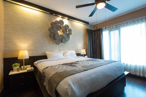 a bedroom with a large bed with a ceiling fan at Baan Sandao D201 in Hua Hin