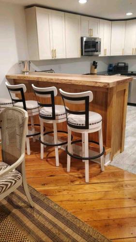 a kitchen with a bar with four chairs and a counter at Lake Hartwell Frank Howard Home in Anderson
