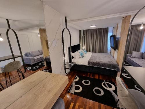 a bedroom with a bed and a table in a room at Apartman Vučko 118 in Jahorina
