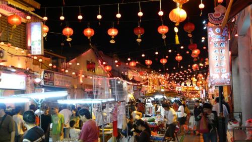 a crowd of people walking through a market with lanterns at Hallmark Leisure Hotel in Melaka