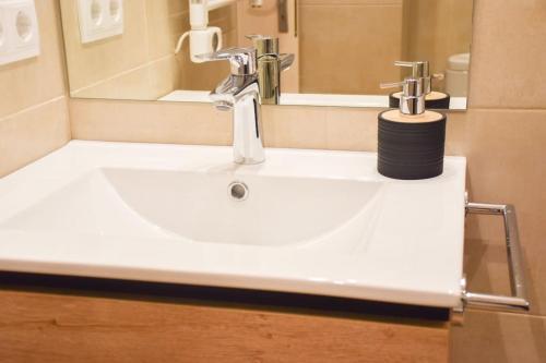 a white sink in a bathroom with a mirror at Envalira Vacances - Menta in Pas de la Casa