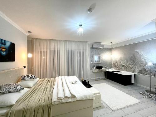 una camera con un grande letto e una scrivania di AM Apartments 13 Timisoara a Timişoara