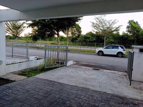 a white car parked on the side of a road at AWANA HOMESTAY in Sungai Petani