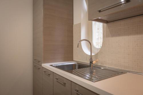 a kitchen with a sink and a mirror at Le Villette - Taormina in Taormina