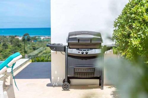 a grill sitting on the side of a patio at Silver Beach 3br Sea View Pool&Wine Private Villa in Chaweng