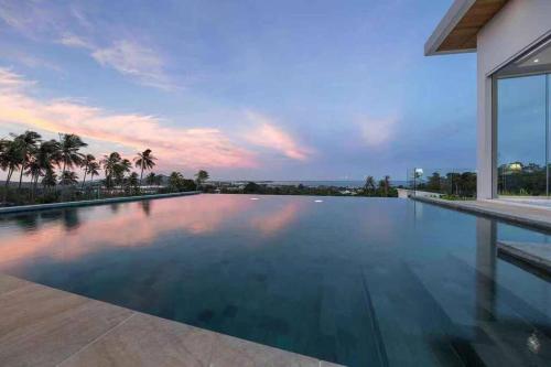 a swimming pool in a house with a sunset at Silver Beach 3br Sea View Pool&Wine Private Villa in Chaweng