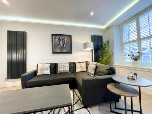 a living room with a couch and a table at Modern 3 Bedroom Apartment, West End in Edinburgh