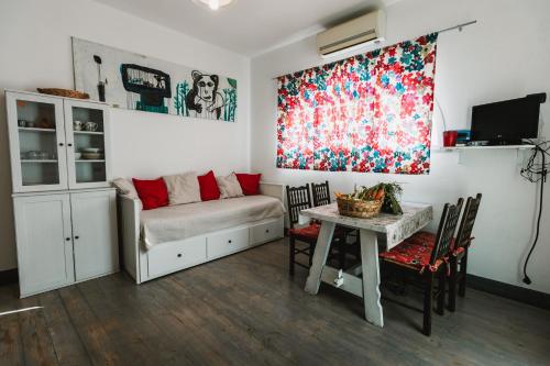 a living room with a couch and a table at Agriturismo Rose di Pietra in Pietra Ligure