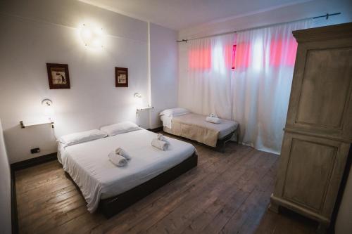 a bedroom with two beds with towels on them at Agriturismo Rose di Pietra in Pietra Ligure