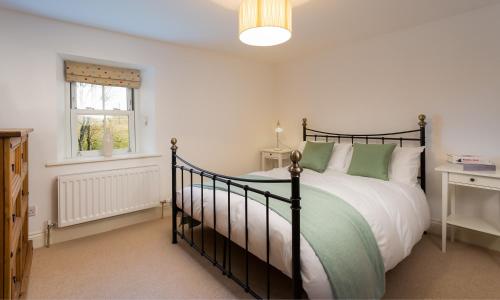 a bedroom with a large bed and a window at Beck View in Troutbeck