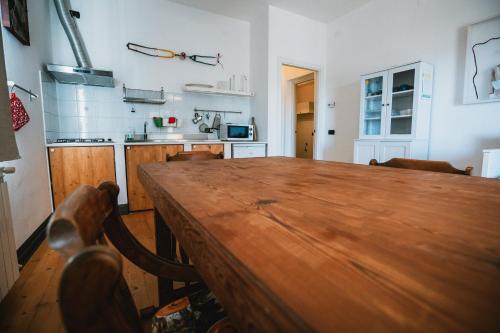 a kitchen with a wooden table in a room at Agriturismo Rose di Pietra in Pietra Ligure