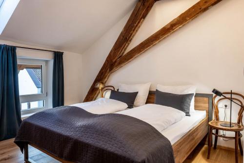 1 dormitorio con 2 camas y ventana en Eichhof Apartment Wacholder en Termeno