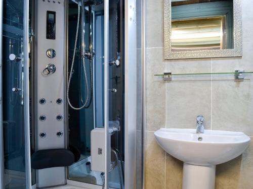 a bathroom with a sink and a shower at Darcis Lodge - Uk1297 in Threlkeld