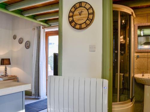 a clock on the wall of a kitchen with a sink at Lucys Lodge - Uk1260 in Threlkeld