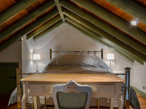 a bedroom with a bed and two chairs in a attic at Lucys Lodge - Uk1260 in Threlkeld