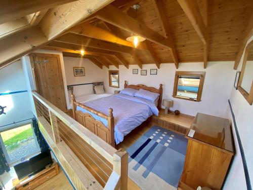 a bedroom with a large bed in a house at The Boat House in Lochmaddy