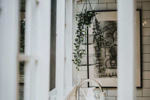 a room with a window with plants on the wall at The Station House Daylesford in Daylesford