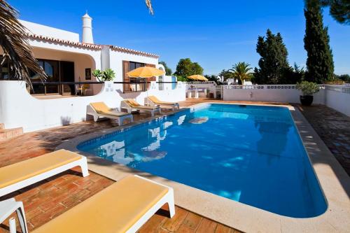 a swimming pool in front of a house at Casa ADM42 in Carvoeiro