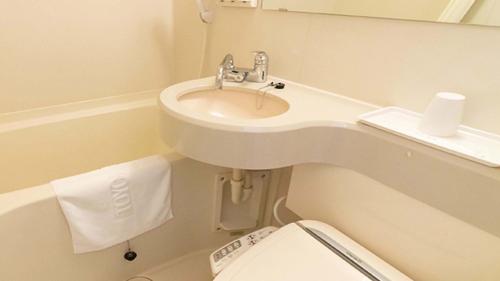 a small bathroom with a sink and a toilet at Toyoko Inn Kyoto Biwako Otsu in Otsu