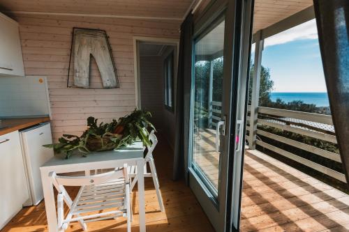 a kitchen with a table and chairs on a balcony at Agriturismo Rose di Pietra in Pietra Ligure