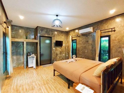 a bedroom with a large bed in a room at Hanoii House in Ko Mak